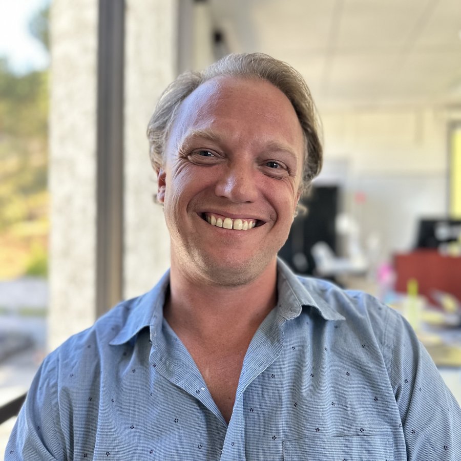 Kirk Faulkner smiling in a blue shirt